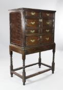A late 17th century oak chest on stand, fitted two short and three long drawers with geometric