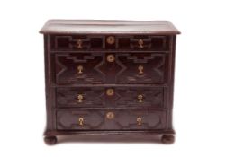 A WILLIAM AND MARY OAK CHEST OF DRAWERS, CIRCA 1690, the cleated plank top above four geometric