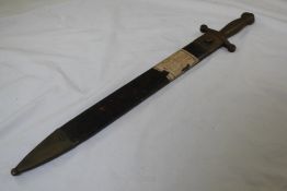 A 19th century short sword, possibly Russian, with brass handle and part serrated saw-back blade,