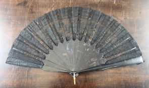 A late 19th / early 20th century tortoiseshell and black lace fan, the upper guard stick with