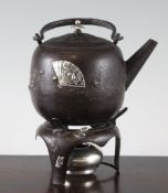 An early 20th century Goram & Co silver and iron Japanese style kettle and burner, the ovoid body