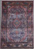 An Isfahan silk rug, with central lozenge shaped medallion within a polychrome field of scrolls