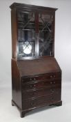A 19th century mahogany bureau bookcase, with astragal glazed top, sloping fall front and four