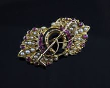 An Edwardian gold, ruby and split pearl set brooch, the centre with crossed horseshoe and riding