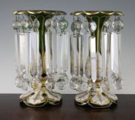 A pair of Bohemian green and white overlaid glass table lustres, late 19th century, the trumpet