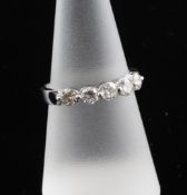 An 18ct white gold and five stone diamond half hoop ring, size O.