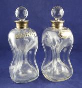 A pair of Edwardian silver mounted decanters and stoppers, of waisted hourglass form, Hukin &