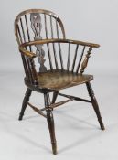 A 19th century elm seat Windsor armchair, with pierced splat back, on turned legs with H frame