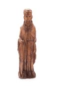 A 15TH CENTURY CARVED WOOD FIGURE OF A SAINT, probably Saint Anthony, carved in the round, some