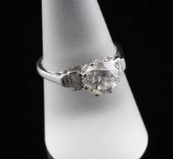 A 1930`s platinum and solitaire diamond ring, with graduated baguette cut diamond shoulders, the
