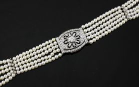 A five strand cultured pearl and diamond link choker necklace with 18ct white gold and diamond set