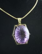 An 18ct gold and amethyst pendant necklace, the large oval cut amethyst with fancy cut culet and