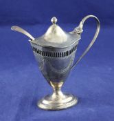 A late Victorian silver pedestal mustard, of vase form, with pierced shoulder and engraved swag