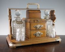 A late Victorian Betjemanns Patent oak and silver plated tantalus with integral drawers and