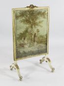 A 19th century cream painted and parcel gilt fire screen, the tapestry panel depicting a young