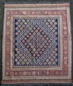 An Anatolian kelim, with field of stylised flower heads on a blue ground, with border of geometric