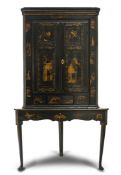 A BLACK AND GOLD JAPANNED CORNER CUPBOARD ON STAND, GEORGE III AND LATER, the moulded cornice