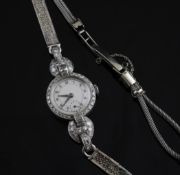 A lady`s 1950`s/1960`s Roidor platinum and diamond manual wind cocktail watch, with circular
