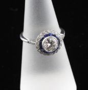 A 1940`s style white gold, sapphire and diamond cluster target ring, with central collet set round
