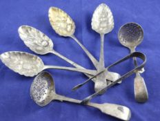 A pair of George III silver Old English pattern "berry" spoons, with later embossed decoration,