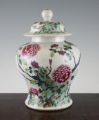 A Chinese famille rose squat baluster vase and cover, 19th century, painted with flowers, blossom