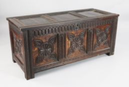 An 18th century carved oak coffer, with triple panel front, the central panel with the monogram ME