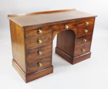A 19th century mahogany kneehole desk, fitted an arrangement of nine drawers with embossed brass