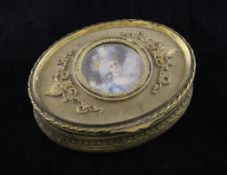 A 19th century French oval gilt brass trinket box, the lid with central oval painted miniature of