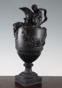 A Wedgwood black basalt Bacchic ewer, 19th century, the neck and body modelled with a satyr grasping