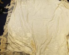 A Chinese ivory-coloured silk shawl, early 20th century, embroidered in matching tones with