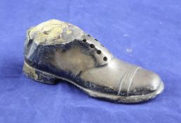 An Edwardian novelty silver pin cushion, modelled as a gentleman`s shoe, with wooden base, S.