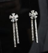 A pair of white gold and diamond drop earrings, of flowerhead form with twin bar drops, set with