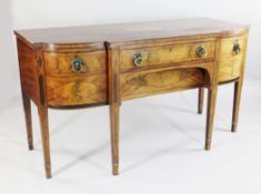 An early 19th century mahogany and satinwood banded breakfront sideboard, the top with oval