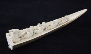 A Japanese ivory okimono, Meiji period, carved as five rabbits in a rowing boat, the exterior of the