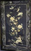 A Chinese embroidered silk and metal thread panel, decorated with a mythical beast, flowers and a