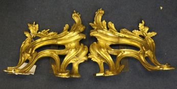 A pair of 19th century, Louis XV style gilt bronze chenets, with scrolled acanthus and oak leaves,