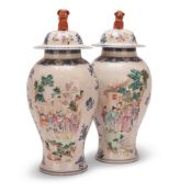 A PAIR OF CHINESE FAMILLE ROSE LIDDED VASE, EARLY 19TH CENTURY, of baluster form, with narrative