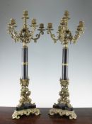 A decorative pair of cast brass candelabra, with six sconces and figural tripartite bases, 27.5in.