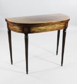A George III mahogany and satinwood crossbanded folding D end card table, with tapering reeded legs,