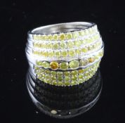 A white gold and pave yellow diamond set dress ring, with reeded shank and seven rows of yellow