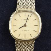 A lady`s 18ct gold Tissot quartz wrist watch, with shaped circular dial and baton numerals, on