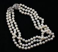 A triple strand cultured pearl choker necklace with 14ct white gold and diamond set foliate design