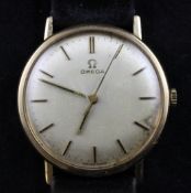 A gentleman`s 1960`s 9ct gold Omega manual wind wrist watch, with baton numerals and case back