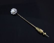 An Edwardian gold and silver split pearl and diamond set stick pin, of flowerhead design, 2.75in.