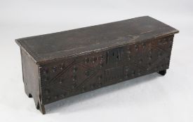 A 17th / 18th century carved oak plank coffer, the front with lozenge carved decoration and date