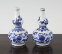 A pair of Chinese blue and white miniature double gourd vases, Kangxi period, each painted with