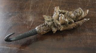A 19th century Black Forest carved wall hook, modelled as a gnome seated on a branch, 12in.