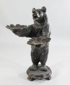 A large late 19th/early 20th century Black Forest carved figure of a standing bear holding two