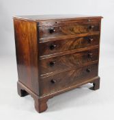 A 19th century mahogany chest, of four long graduated drawers, with brushing slide above, on bracket