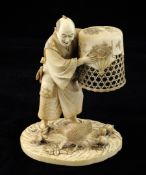 A Japanese ivory group of a man catching chickens, Meiji period, the figure with finely carved